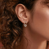 Stud earrings with golden cross and zirconia